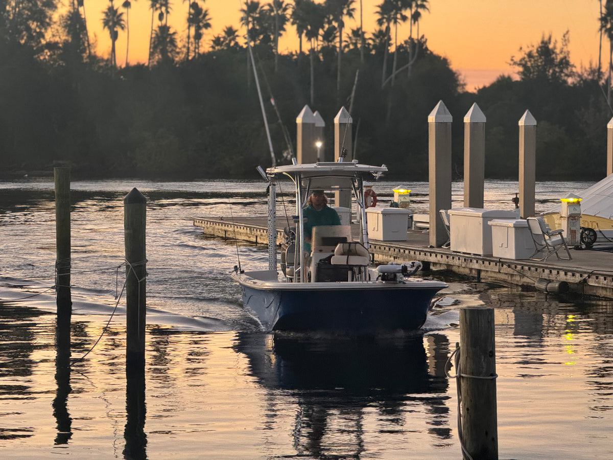 Capt. Eric idling the Carolina Skiff into the marina at sunrise
