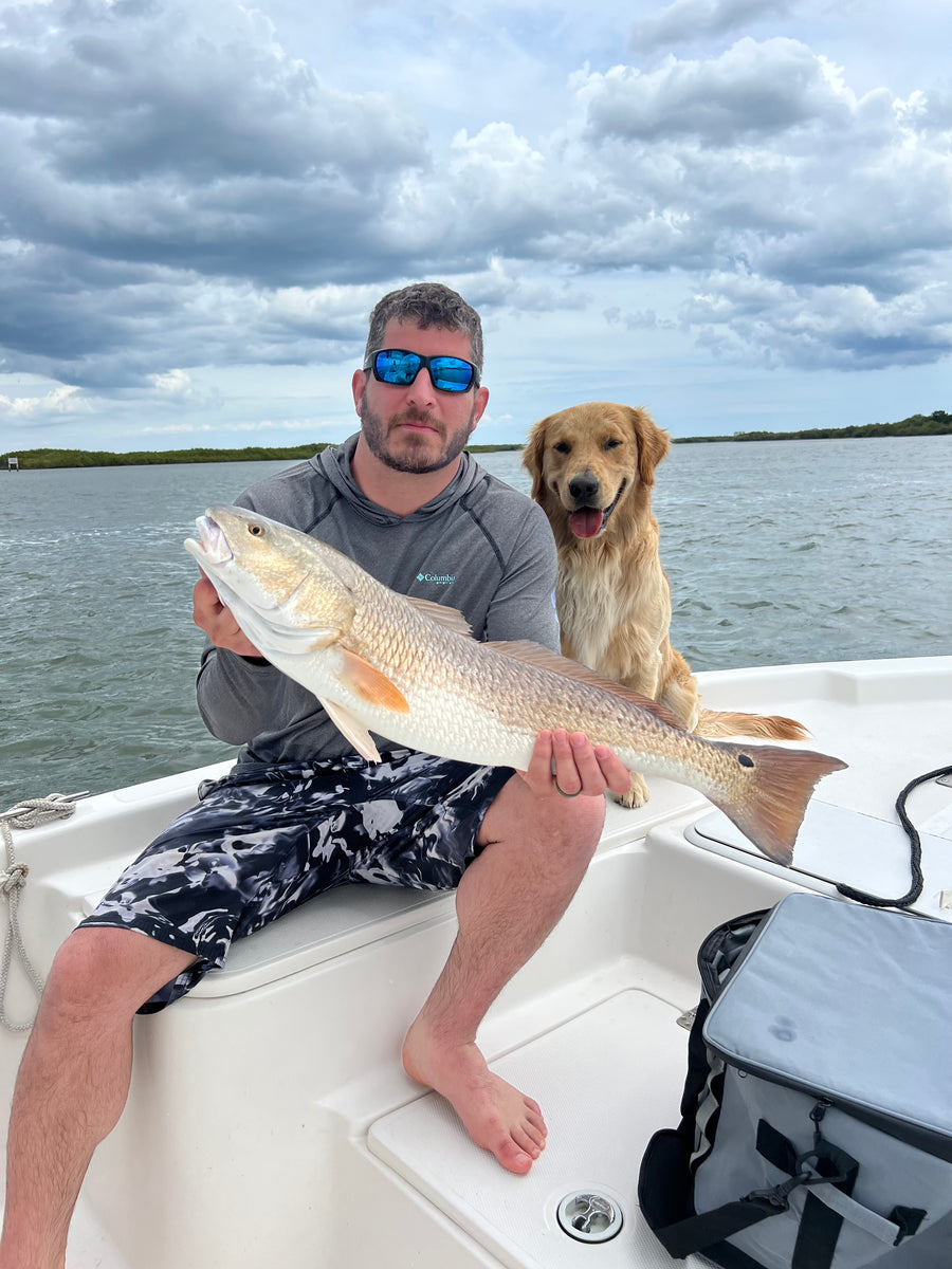 Redfish with the boat dog