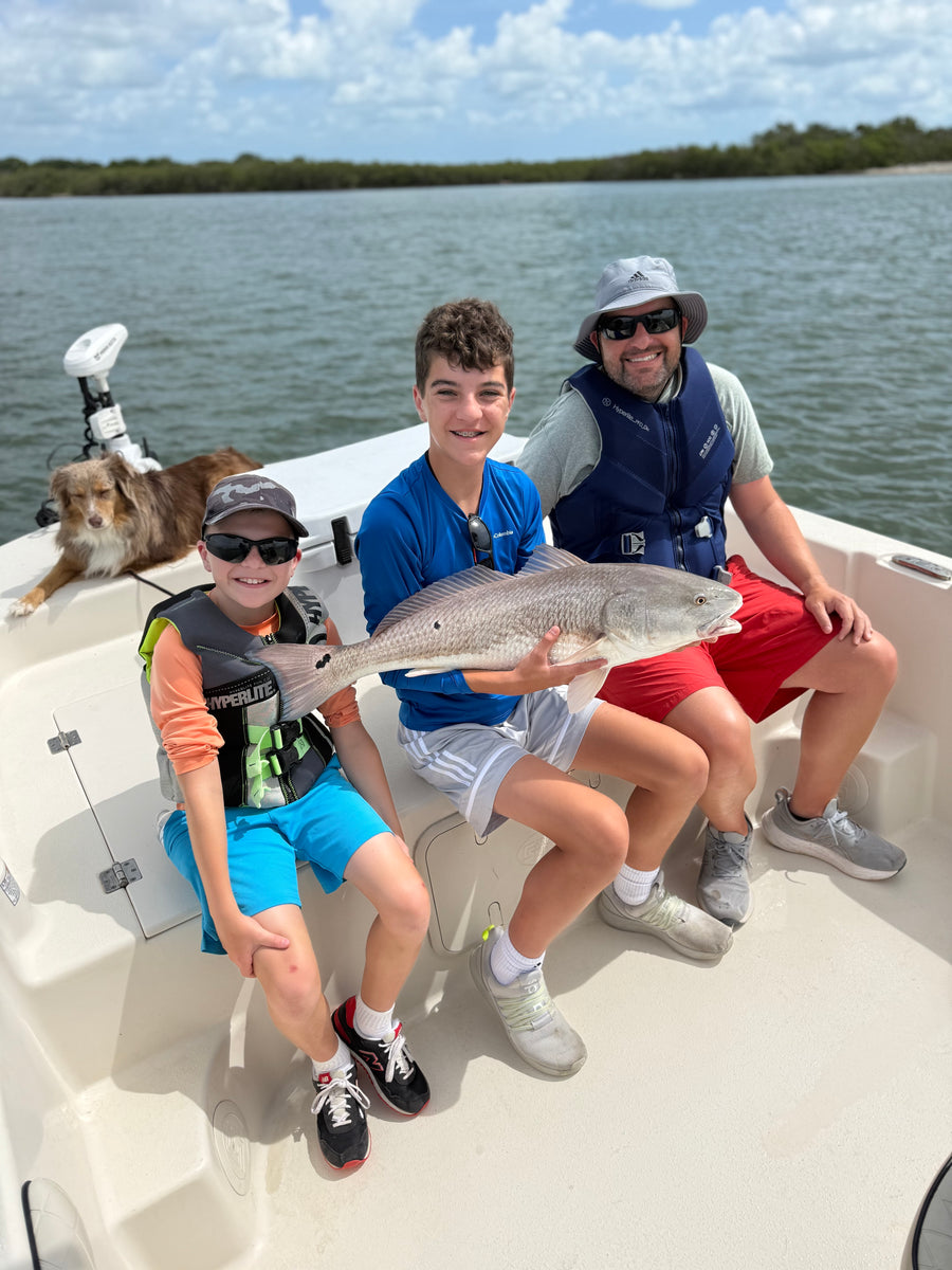 Family with a lagoon redfish